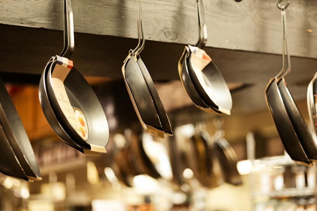 Several pans arranged on a kitchen counter for a condition check