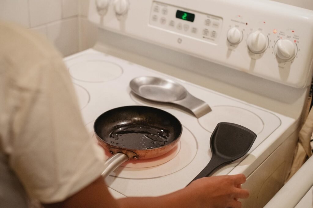 Nonstick pan and stainless skillet arranged side by side on a kitchen counter